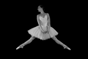Ballet dancer on a black background. The dancer in a dance. Ballet pose. Dancer in a jump