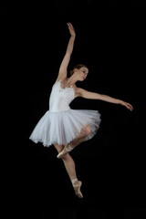 Ballet dancer on a black background. The dancer in a dance. Ballet pose