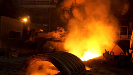 Close up for the electric furnace with melting metal and rising smoke. Stock footage. Metallurgical...