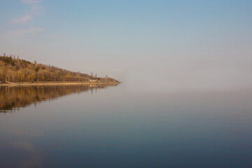 Mirror reflection of the shore in the water