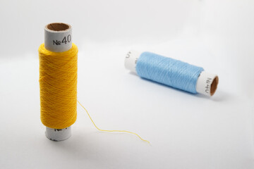 Two spools of thread