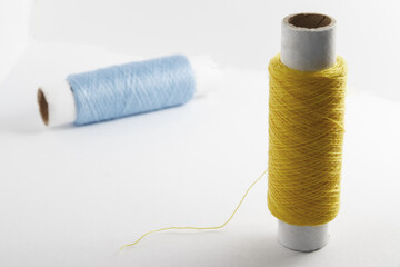 Two spools of thread