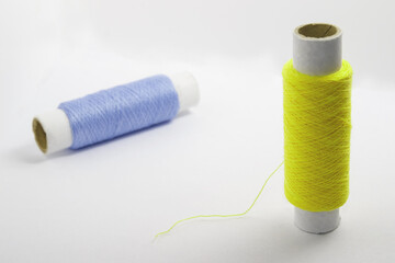 Two spools of thread