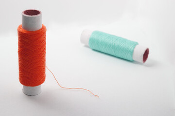 Two spools of thread