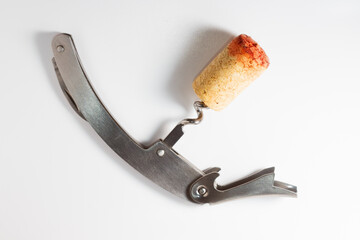 Corkscrew with wine stopper. Cork stoppers with traces of red wine