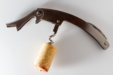 Corkscrew with wine stopper. Cork stoppers with traces of red wine
