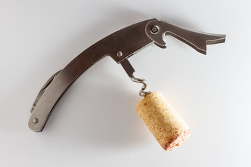 Corkscrew with wine stopper. Cork stoppers with traces of red wine