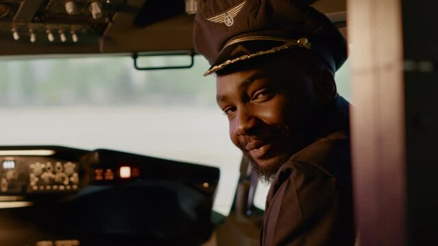 Portrait of african american copilot helping to fly airplane, using dashboard power buttons and power engine to takeoff. Aviation command on control panel with aerial navigation.