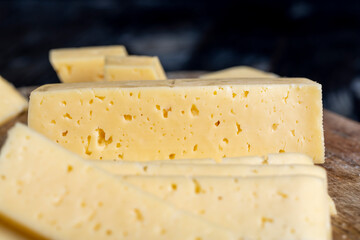 fresh yellow milk cheese on a board