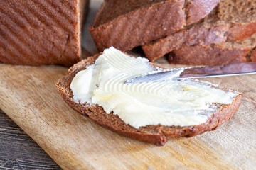 slices of black sliced bread with butter spread from milk