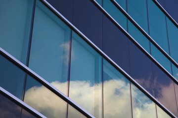 office building windows clouds reflections skyscraper modern business background city corporation commercial structure tower