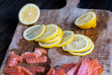 cutting fish fillets during the preparation of a dish of red salmon fish