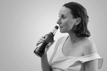 Pregnant woman on an isolated white background. The pregnant woman holds a glass of mineral water. A pregnant woman pours clean water into a glass. 