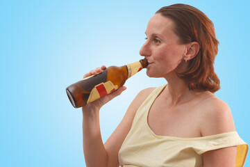 Female alcoholism. Woman drinking beer on the blue background