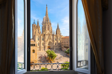 View through an open window from across the plaza of the gothic Barcelona Cathedral in the El Born Gothic Quarter of the Catalonian city of Barcelona, Spain. - obrazy, fototapety, plakaty