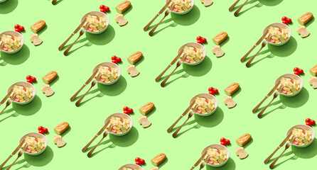 Many bowls of Caesar salad on green background. Pattern for design