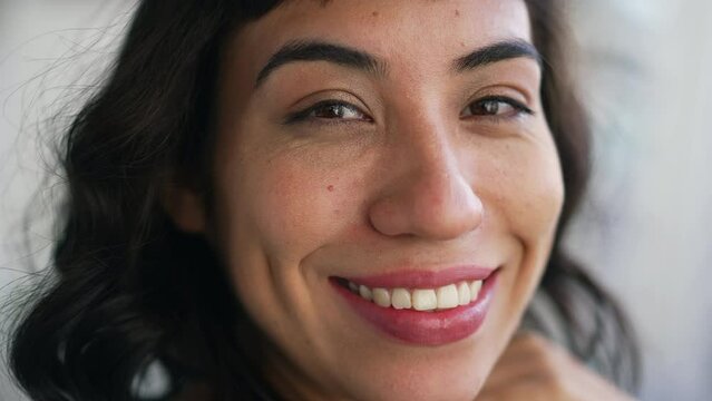 One hispanic latin young woman closeup face smiling at camera. Portrait of a happy South American person