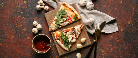 Board with slices of tasty pizza on grunge background, top view