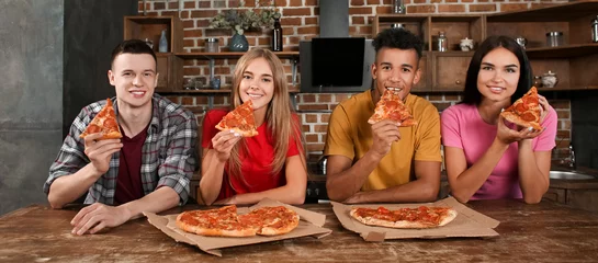 Foto op Canvas Young people eating delicious pizza in kitchen © Pixel-Shot