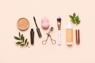 Composition with cosmetics and makeup accessories on pink background