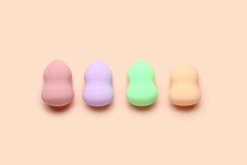 Set of makeup sponges on pink background