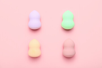 Set of makeup sponges on pink background