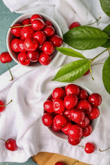 Composition with bowls of sweet cherries on table, closeup
