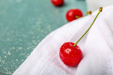 Sweet cherry with water drops on napkin, closeup