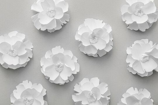 Many paper flowers on grey background