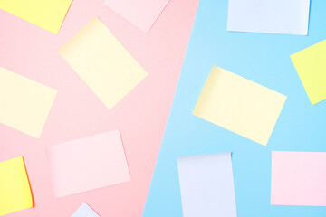 Mock-up of many empty multicolored office stickers on a pink and blue background.