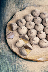 chocolate candies truffles on a wooden board