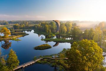 Fototapeta na wymiar Amazing aerial view of Kirkilai karst lakes and lookout tower in the bright sunny autumn morning, Birzai, Lithuania
