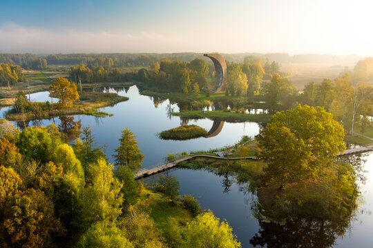 Amazing aerial view of Kirkilai karst lakes and lookout tower in the bright sunny autumn morning, Birzai, Lithuania