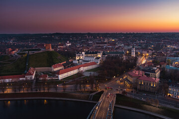 Scenic aerial view of Vilnius Old Town and Neris river at nightfall. Sunset landscape. Vilnius, Lithuania.