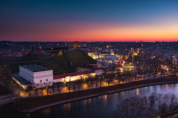 Scenic aerial view of Vilnius Old Town and Neris river at nightfall. Sunset landscape. Vilnius, Lithuania.
