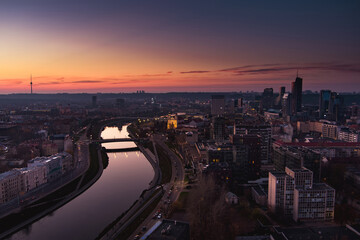 Scenic aerial view of Vilnius Old Town and Neris river at nightfall. Sunset landscape. Vilnius, Lithuania.