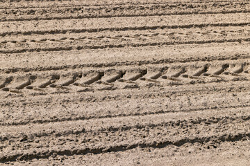 plowed soil in an agricultural field during tillage