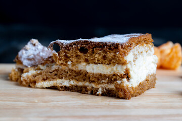 a piece of honey cake with vanilla cream and citrus tangerines