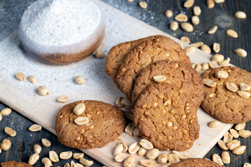 oatmeal cookies with peanuts on a black wooden table