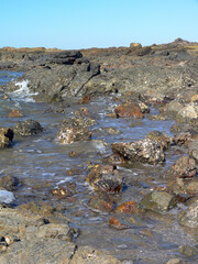 Water in a rock pool at a beach ocean seascape 