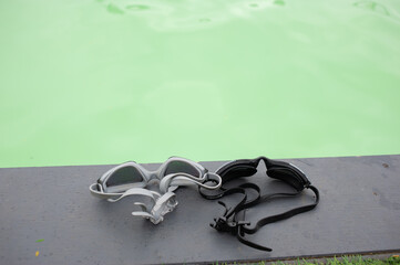 2 goggles, they're at the edge of the pool.