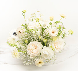 White fresh flower wedding centerpiece with garden roses, ranunculus and anemones