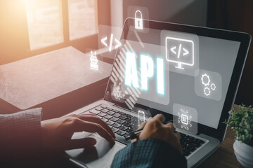 API - Application Programming Interface, Woman using laptop computer with VR screen API icon on office desk, Software development tool, modern technology, internet and networking concept.