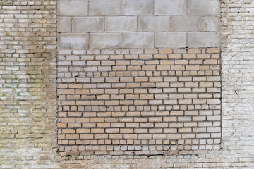 an old brick wall made of a large number of different types of bricks