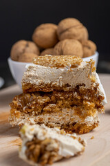 a piece of cake with buttercream and walnuts