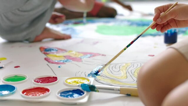 Children, students or toddlers painting, doing art and using paint while in a class at school. Creative, inspired and carefree kids expressing themselves through artwork, creativity and design
