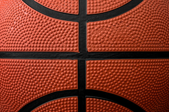 Zoom close up photograph on the bumpy details of a genuine rubber basketball concept for competitive sports backgrounds, athletic competition and sporting event wallpaper
