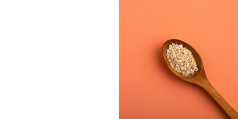 Avena sativa - Oat flakes in the wooden spoon