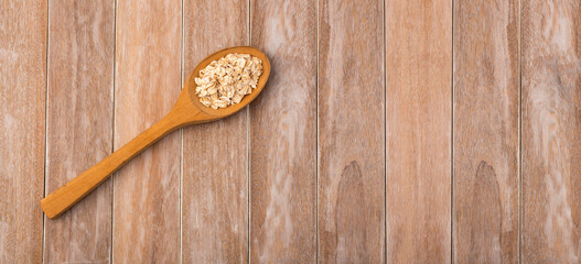 Oat flakes in the wooden spoon - Avena sativa