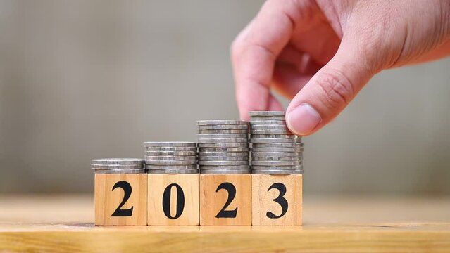 Hand put coin​ on group of coins, Money saving plan for 2023 year concept